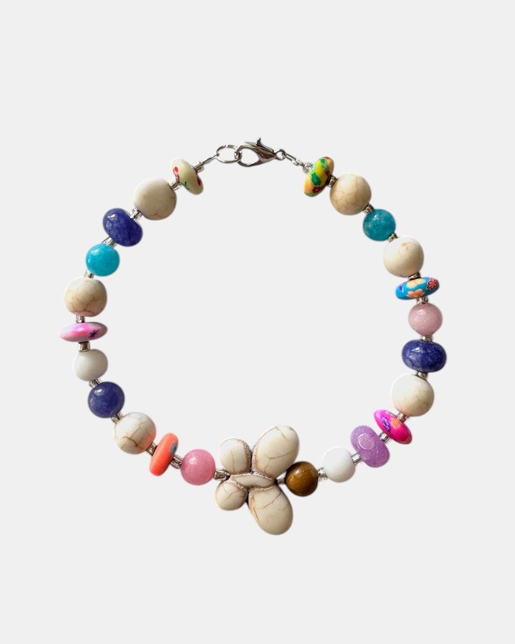 Silver bracelet with ecru and multicolored beads featuring a butterfly charm