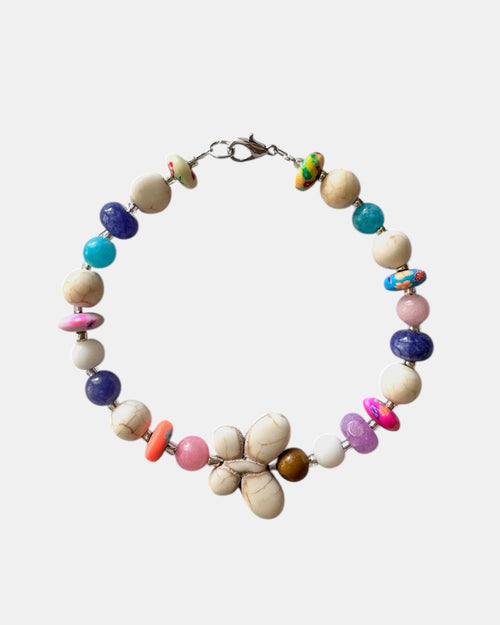 Silver bracelet with ecru and multicolored beads featuring a butterfly charm
