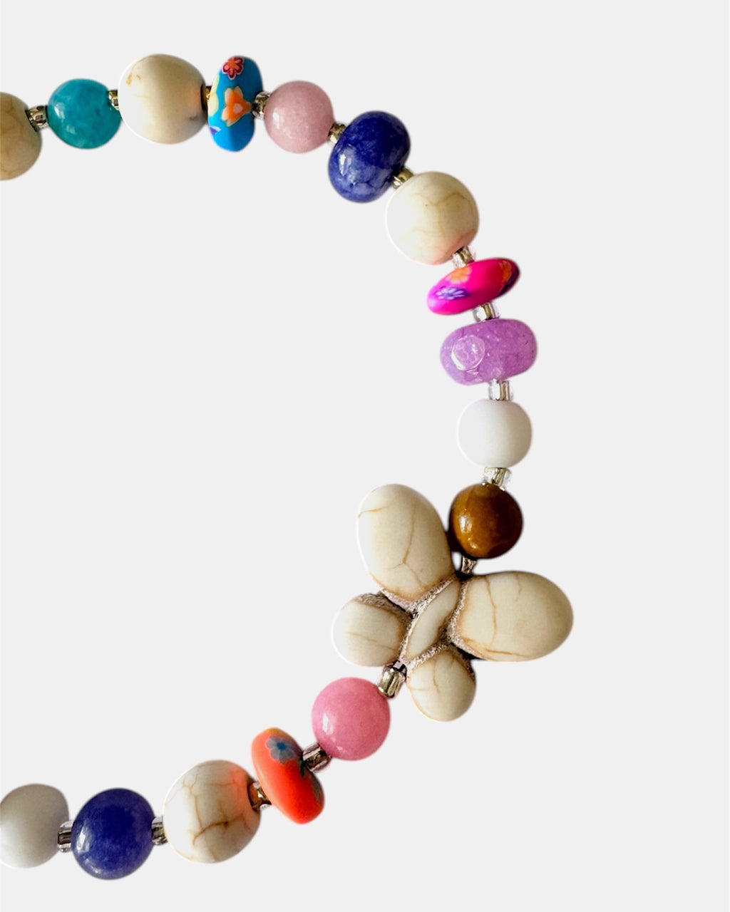 Silver bracelet with ecru and multicolored beads featuring a butterfly charm