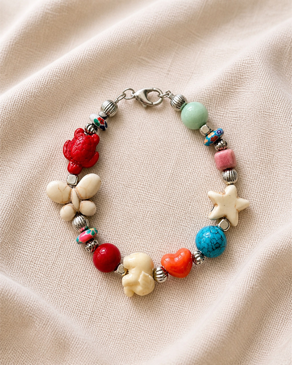 Silver bracelet with multicolored beads and patterns.