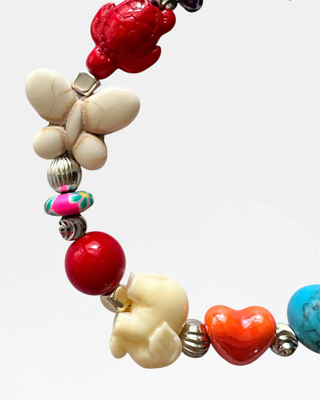 Silver bracelet with multicolored beads and patterns.