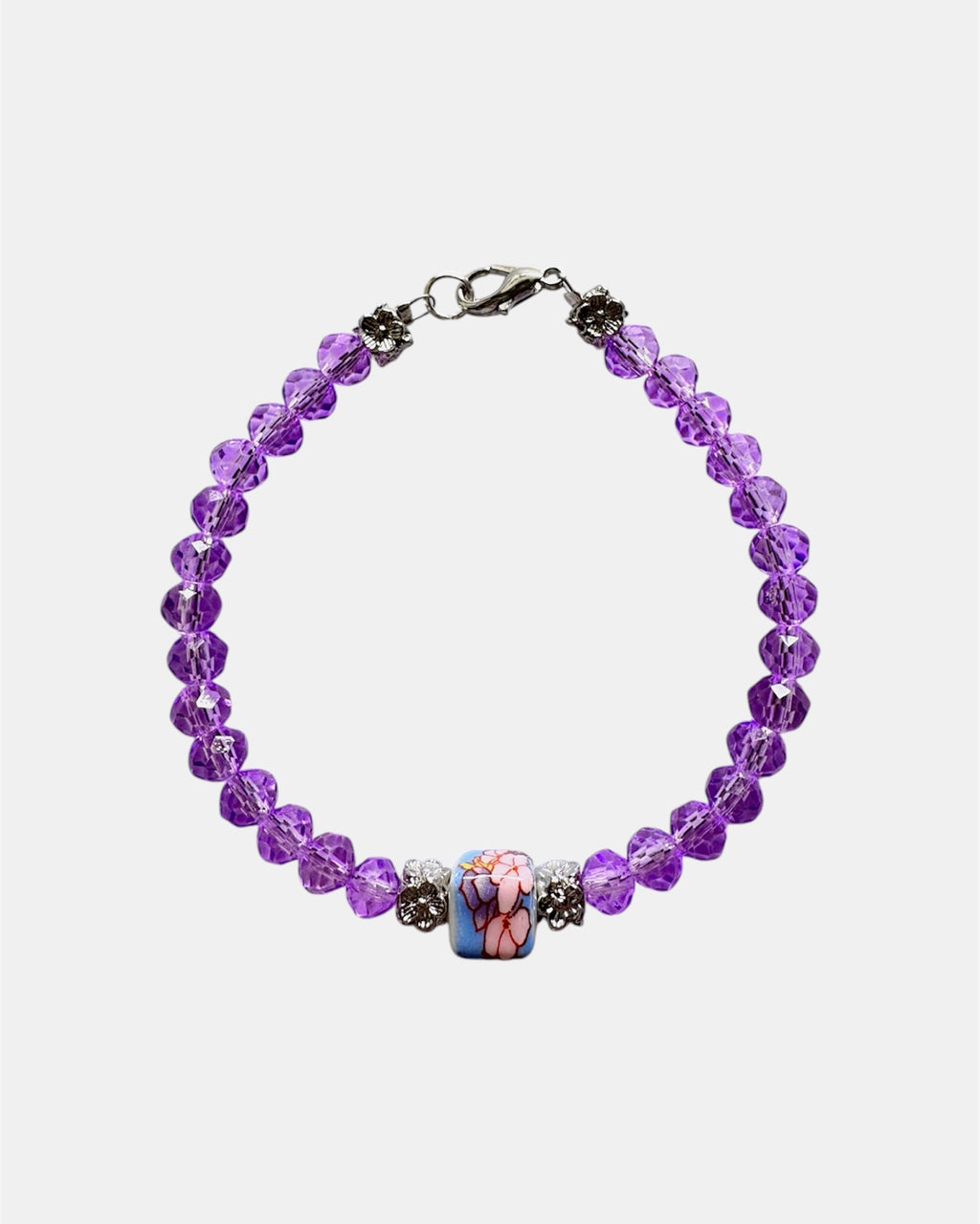 Stylish silver bracelet with purple crystal beads and a ceramic bead, elegant handmade jewelry piece for modern and chic looks