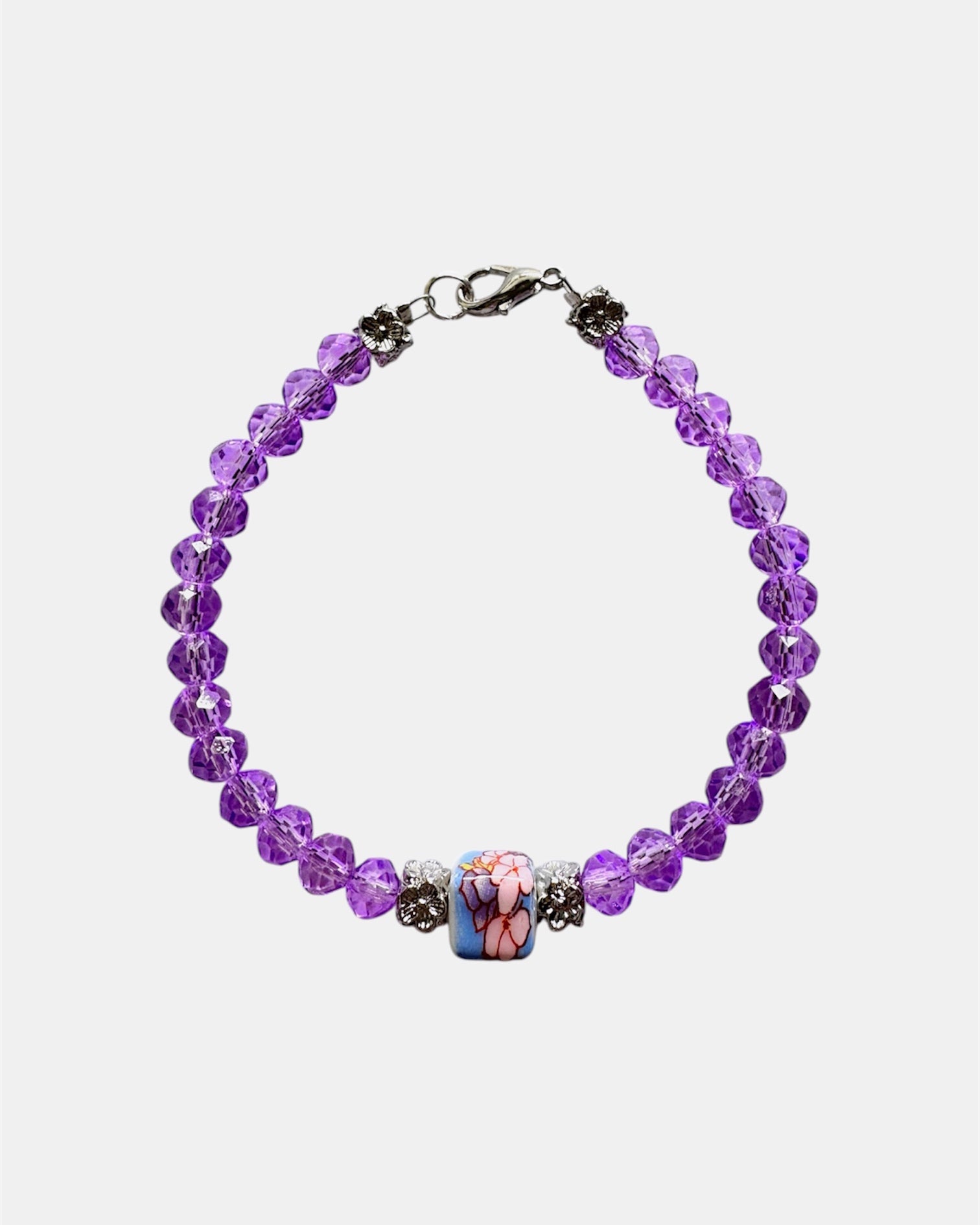Stylish silver bracelet with purple crystal beads and a ceramic bead, elegant handmade jewelry piece for modern and chic looks