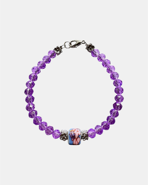 Stylish silver bracelet with purple crystal beads and a ceramic bead, elegant handmade jewelry piece for modern and chic looks