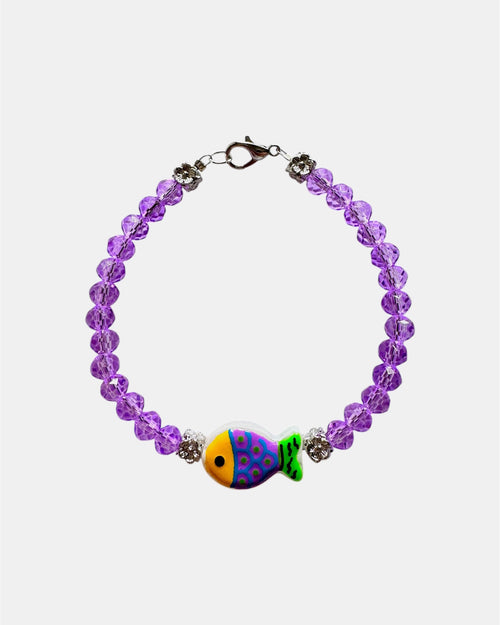 Elegant silver bracelet with purple crystal beads and fish charm, unique handmade jewelry inspired by the sea and modern style