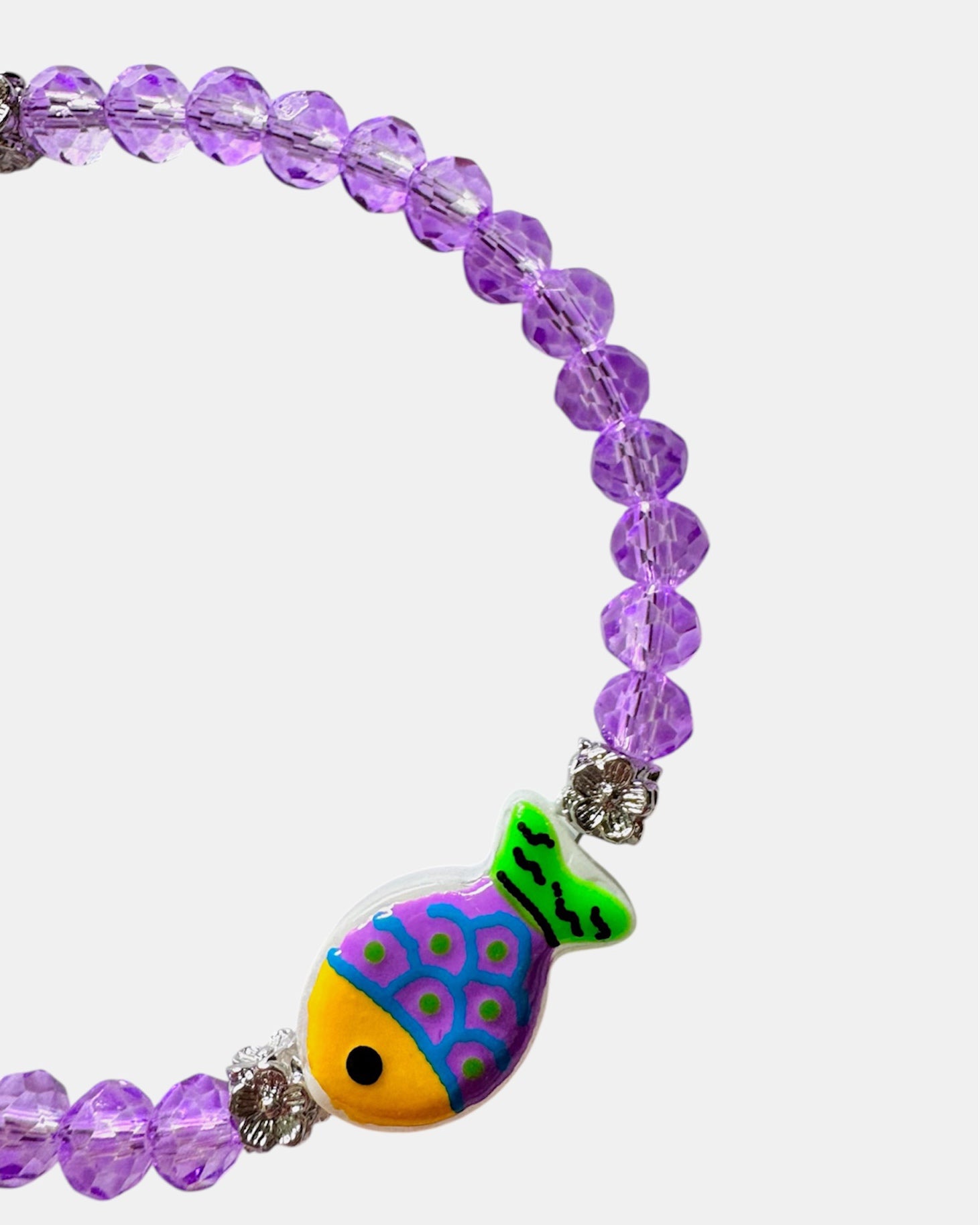 Elegant silver bracelet with purple crystal beads and fish charm, unique handmade jewelry inspired by the sea and modern style