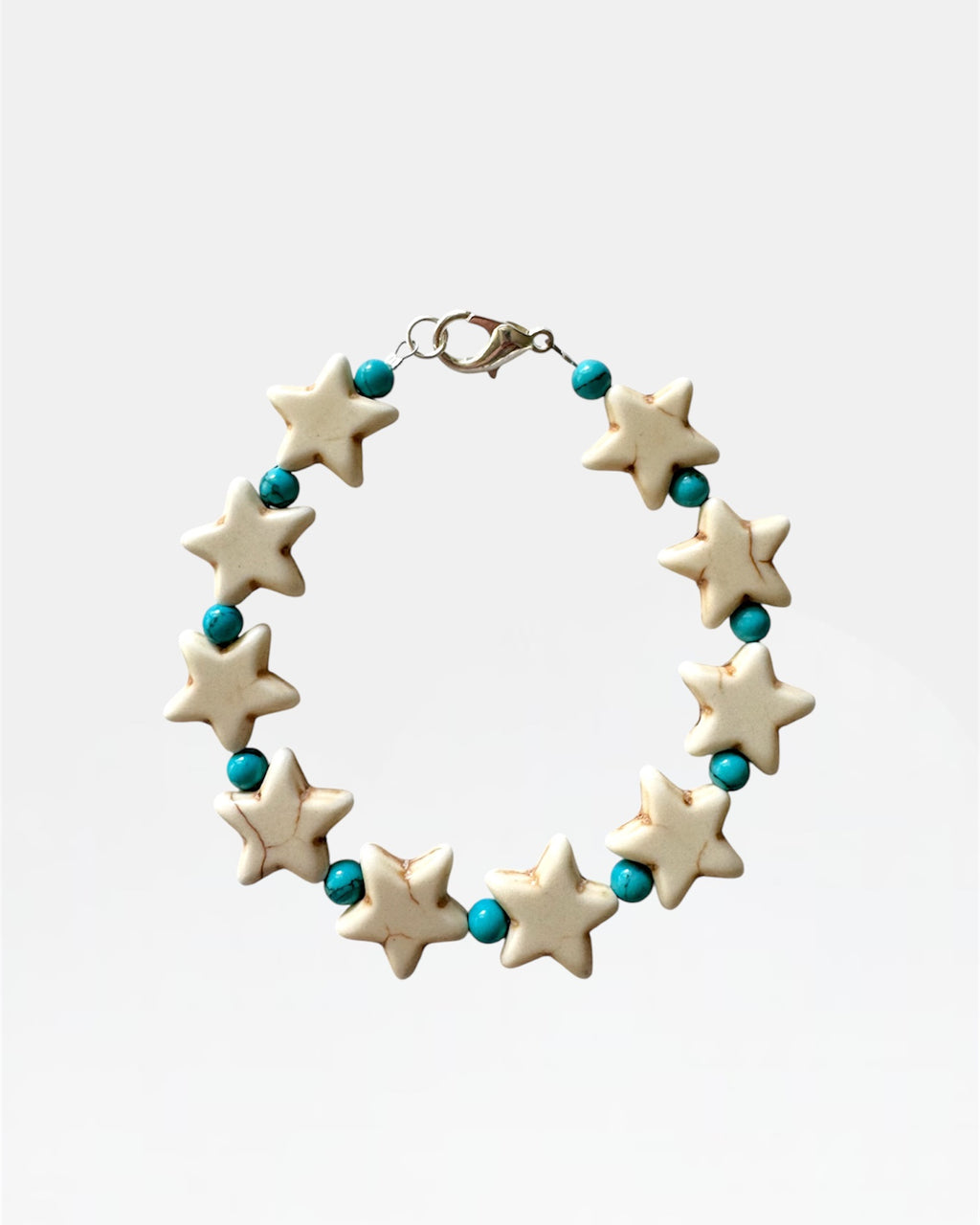 Silver bracelet with stars and turquoise beads.