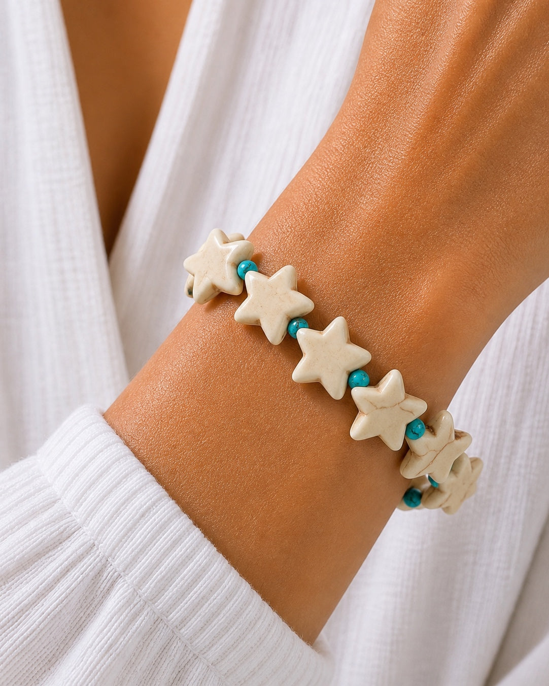 Silver bracelet with stars and turquoise beads.