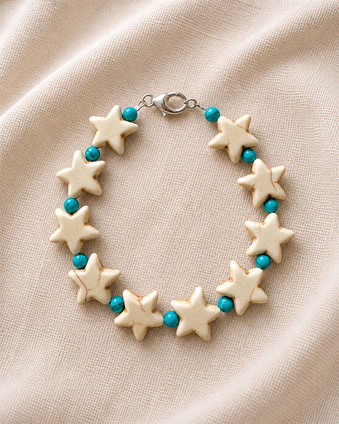 Silver bracelet with stars and turquoise beads.