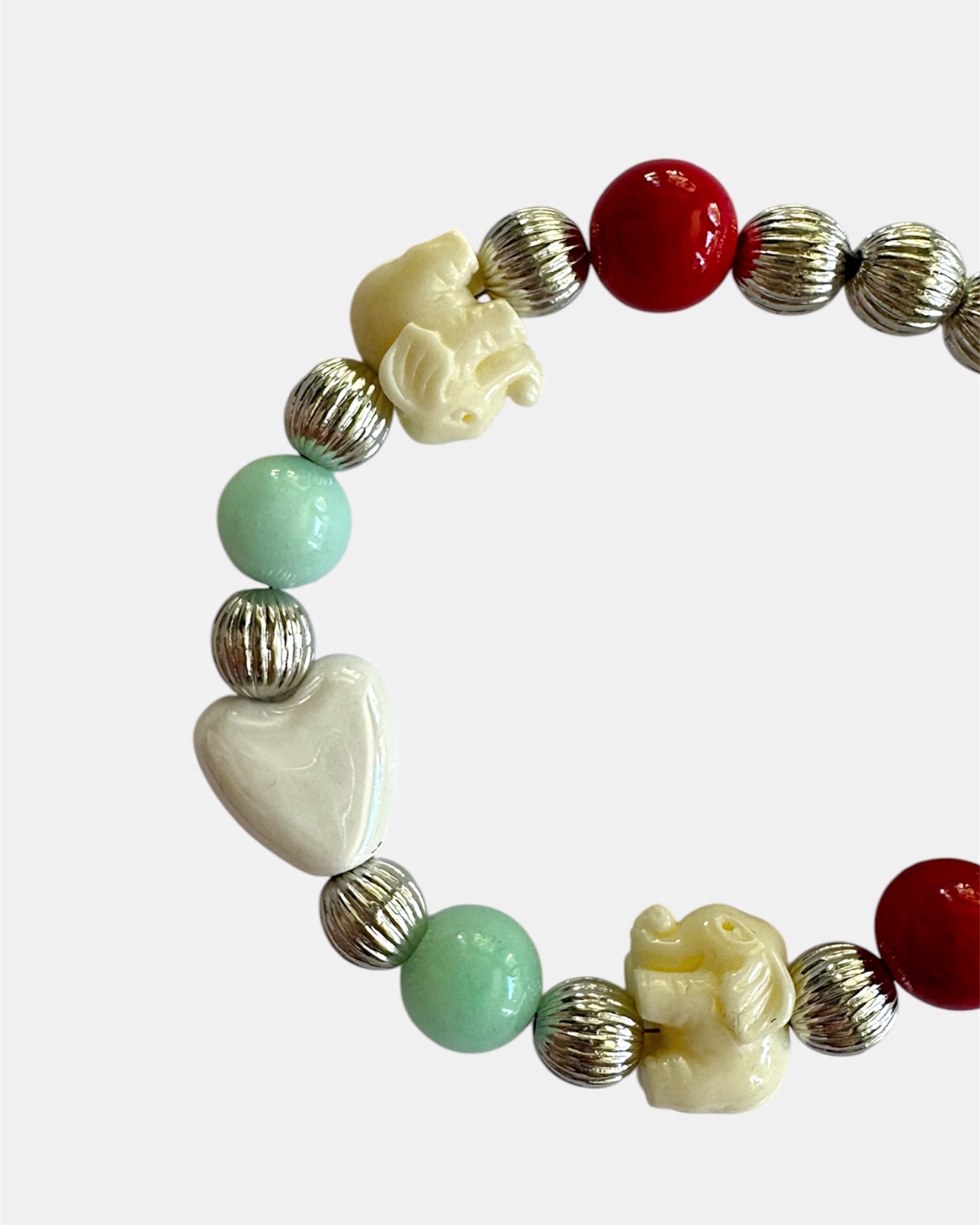 Silver bracelet with elephant charms and heart detail in elegant symbolic style