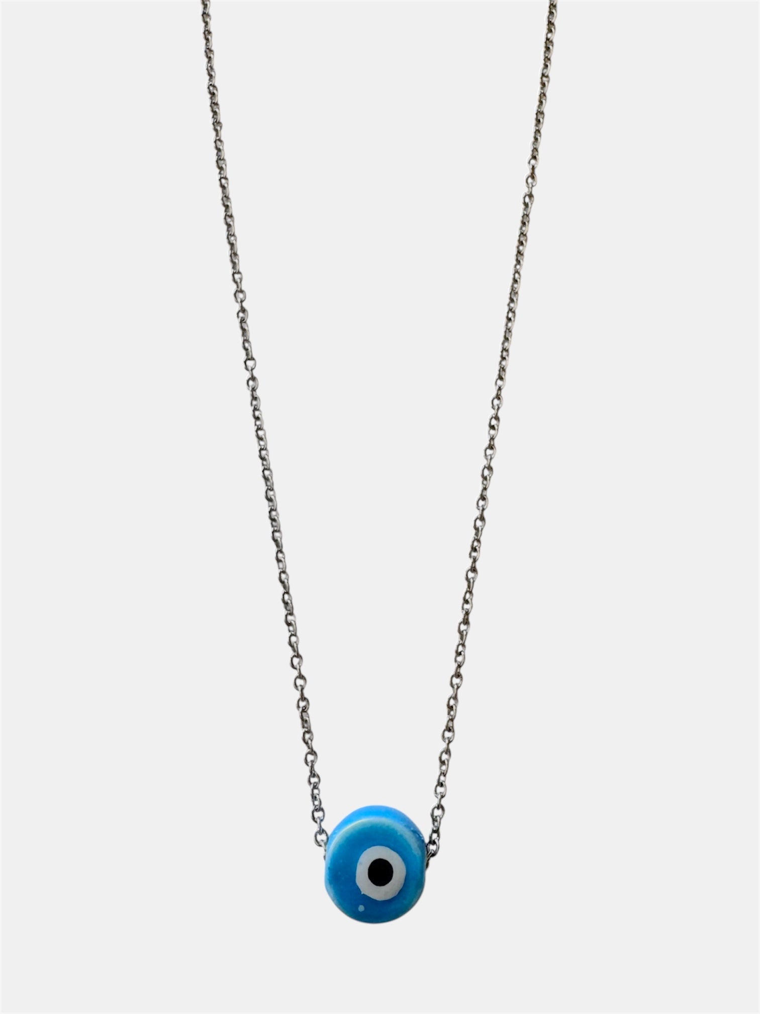 Silver chain necklace with a blue ceramic evil eye charm