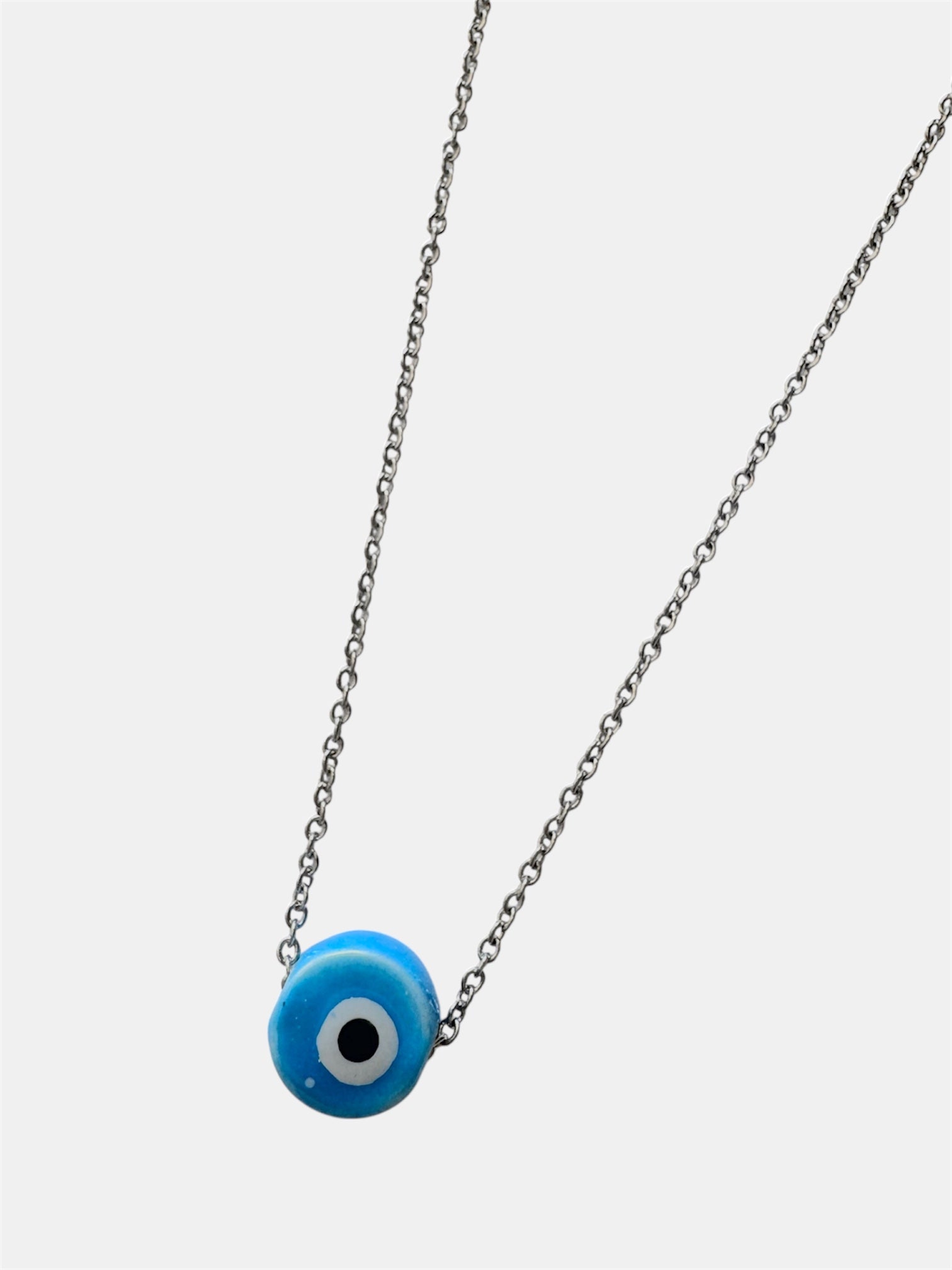 Silver chain necklace with a blue ceramic evil eye charm