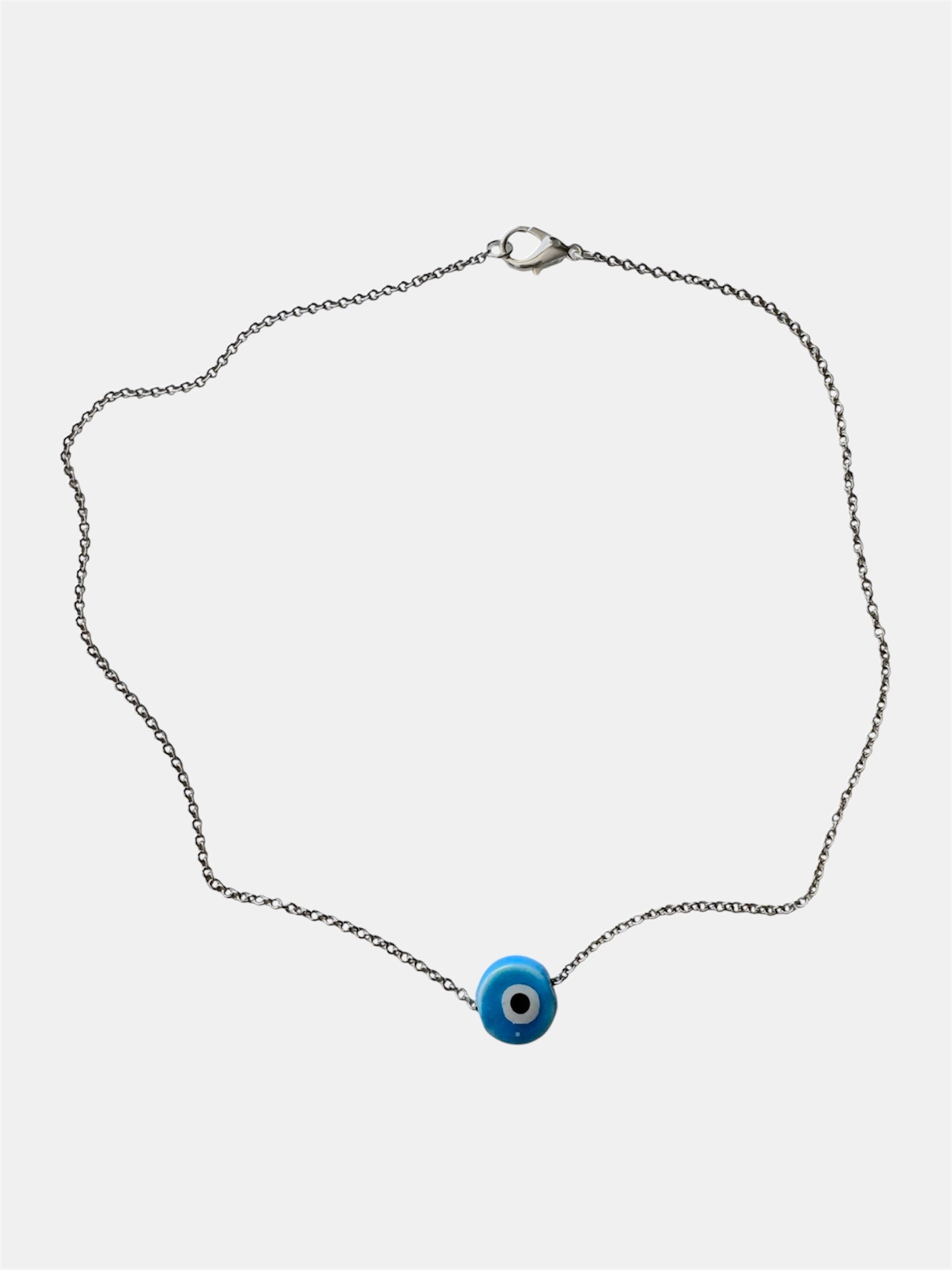 Silver chain necklace with a blue ceramic evil eye charm