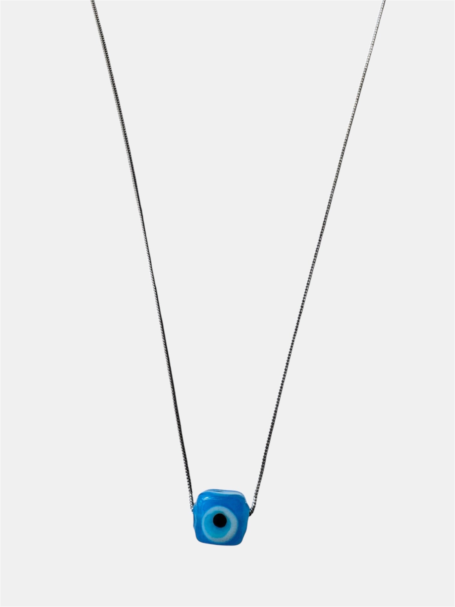 Silver chain necklace with a blue glass evil eye charm
