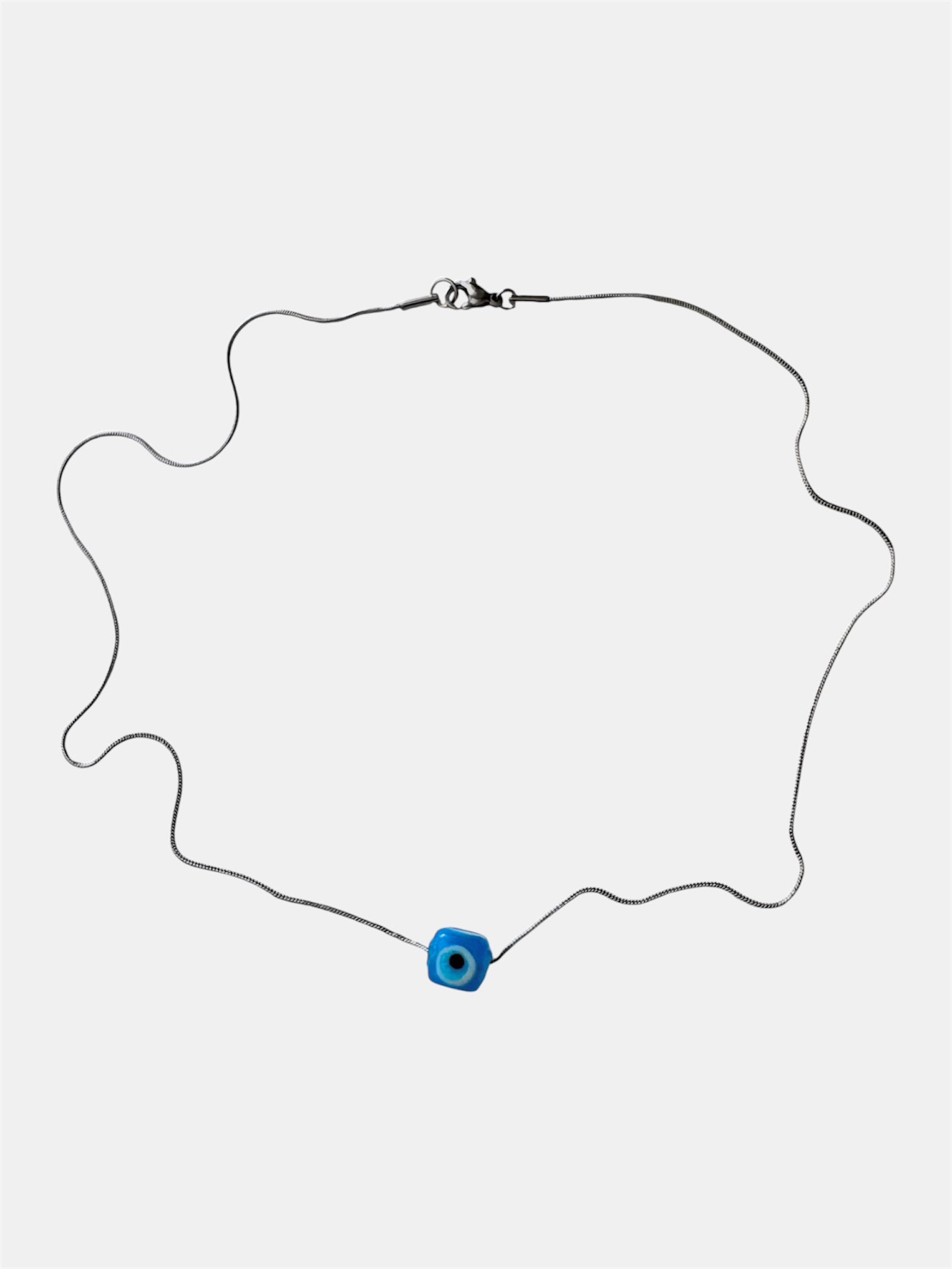 Silver chain necklace with a blue glass evil eye charm
