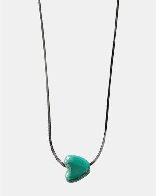 Silver chain necklace with a green heart charm