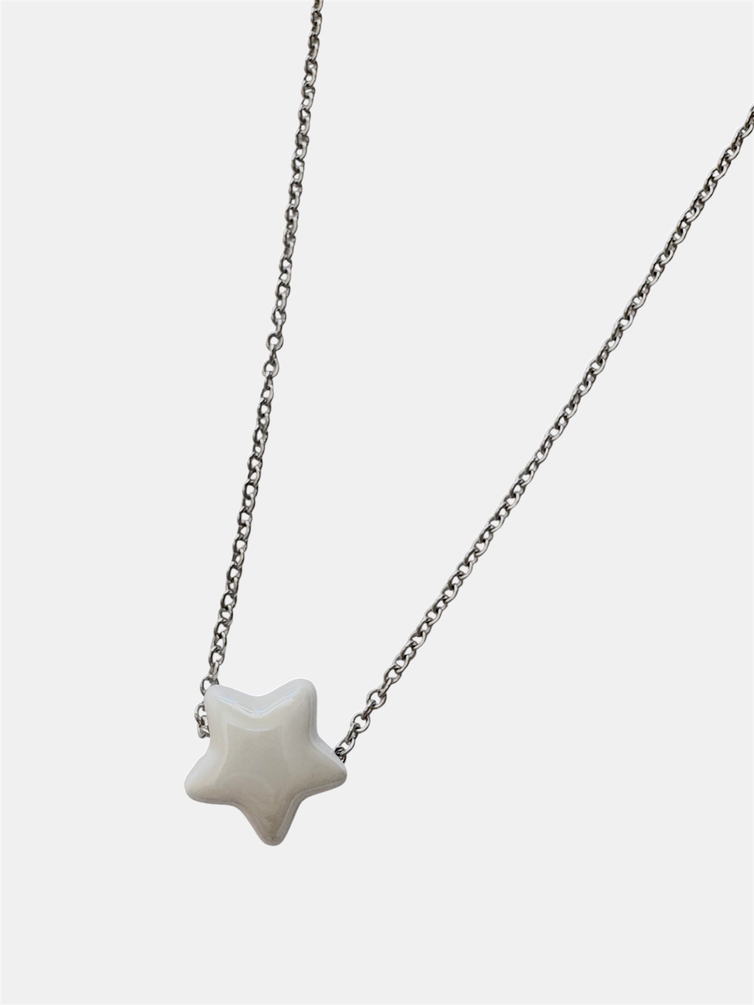 Silver chain necklace with a white ceramic star charm
