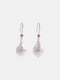 Silver dangling earrings.
