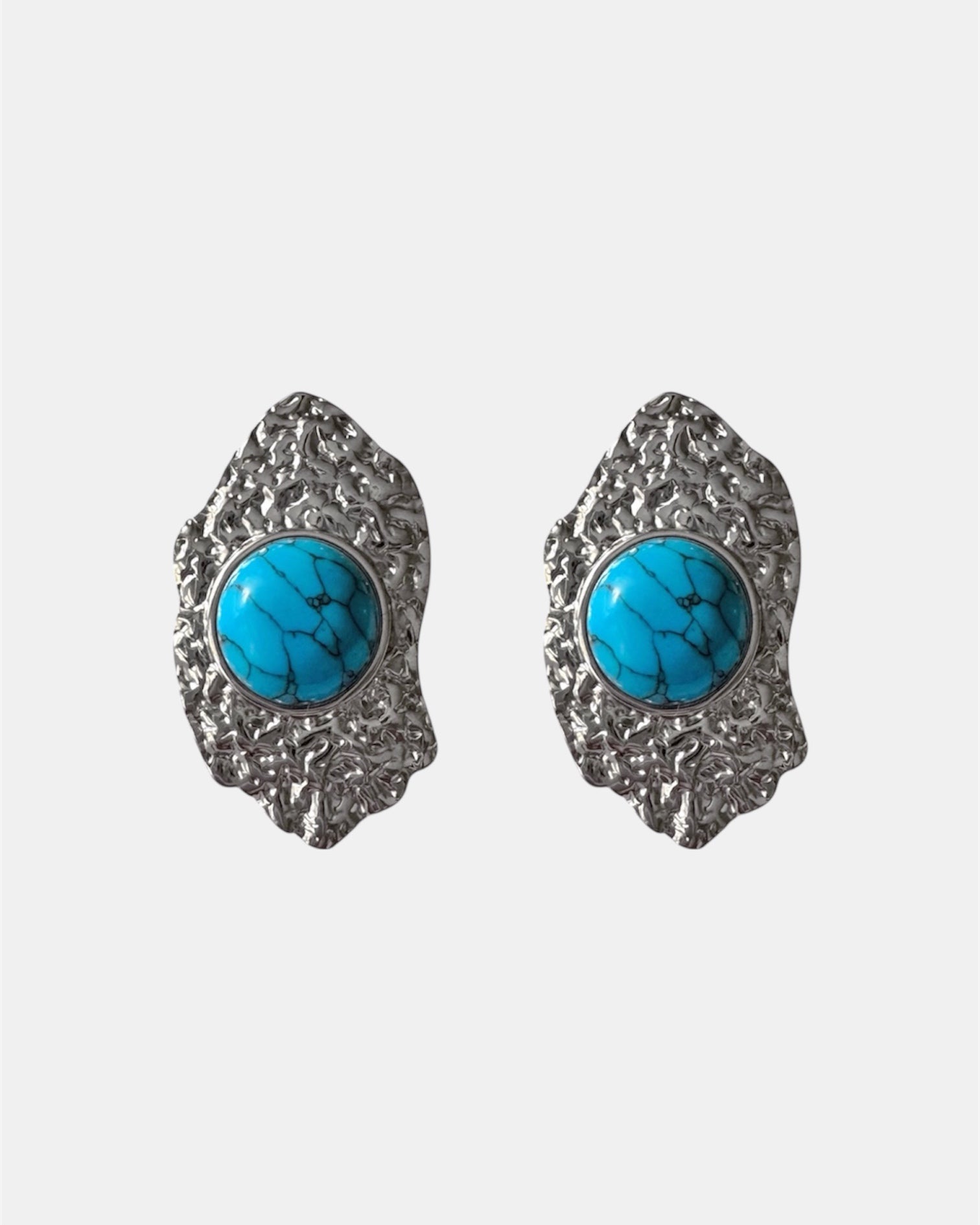 Silver dangling earrings with teal stone.