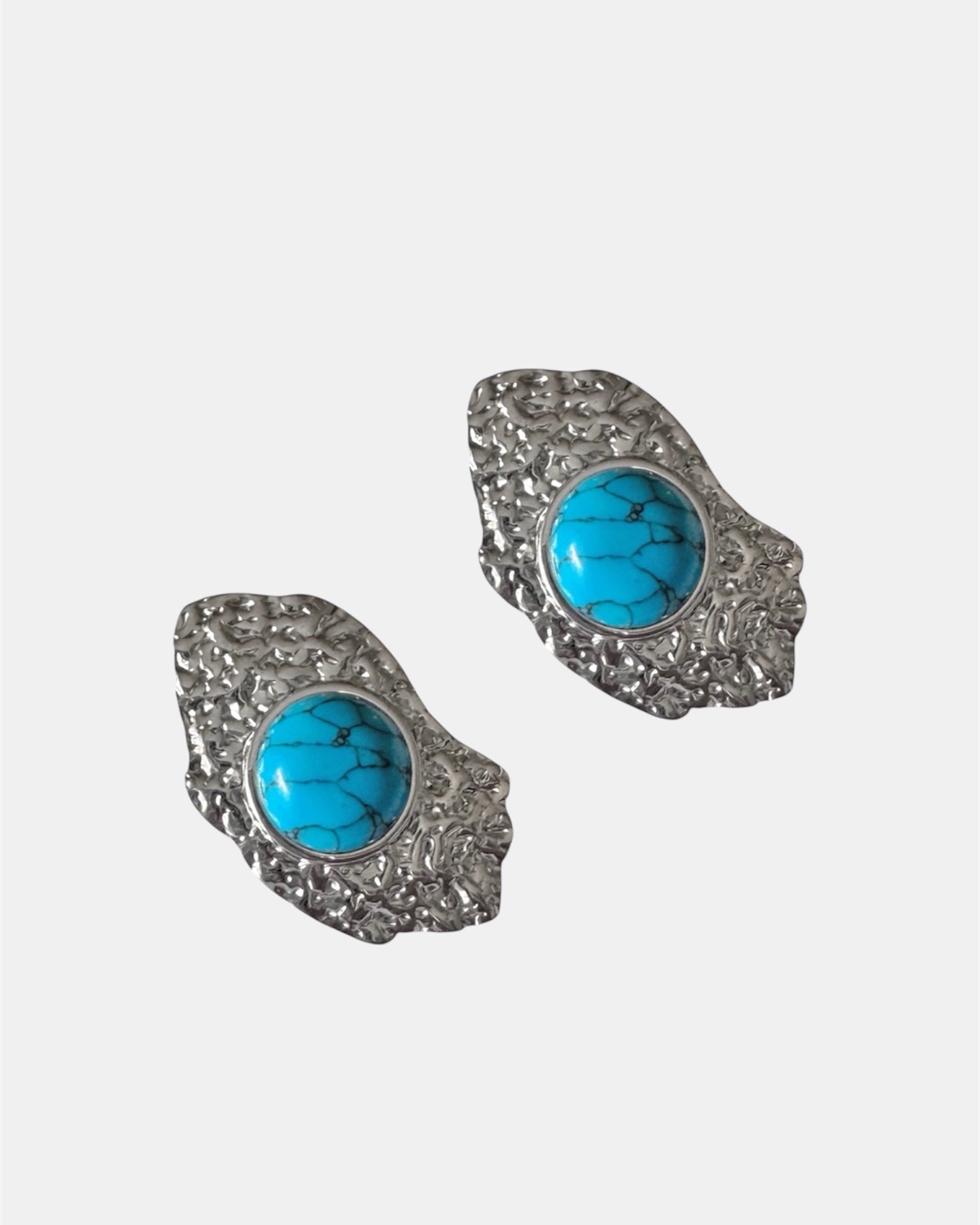 Silver dangling earrings with teal stone.