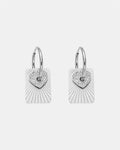 Silver hoop earrings with a heart charm and a flat pendant