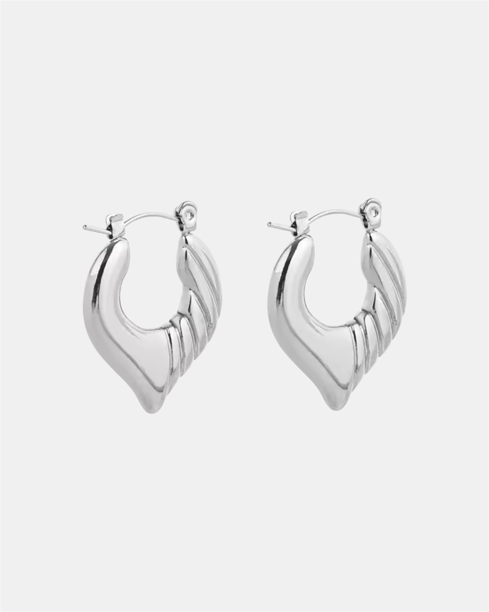 Silver hoop earrings with twisted heart design.