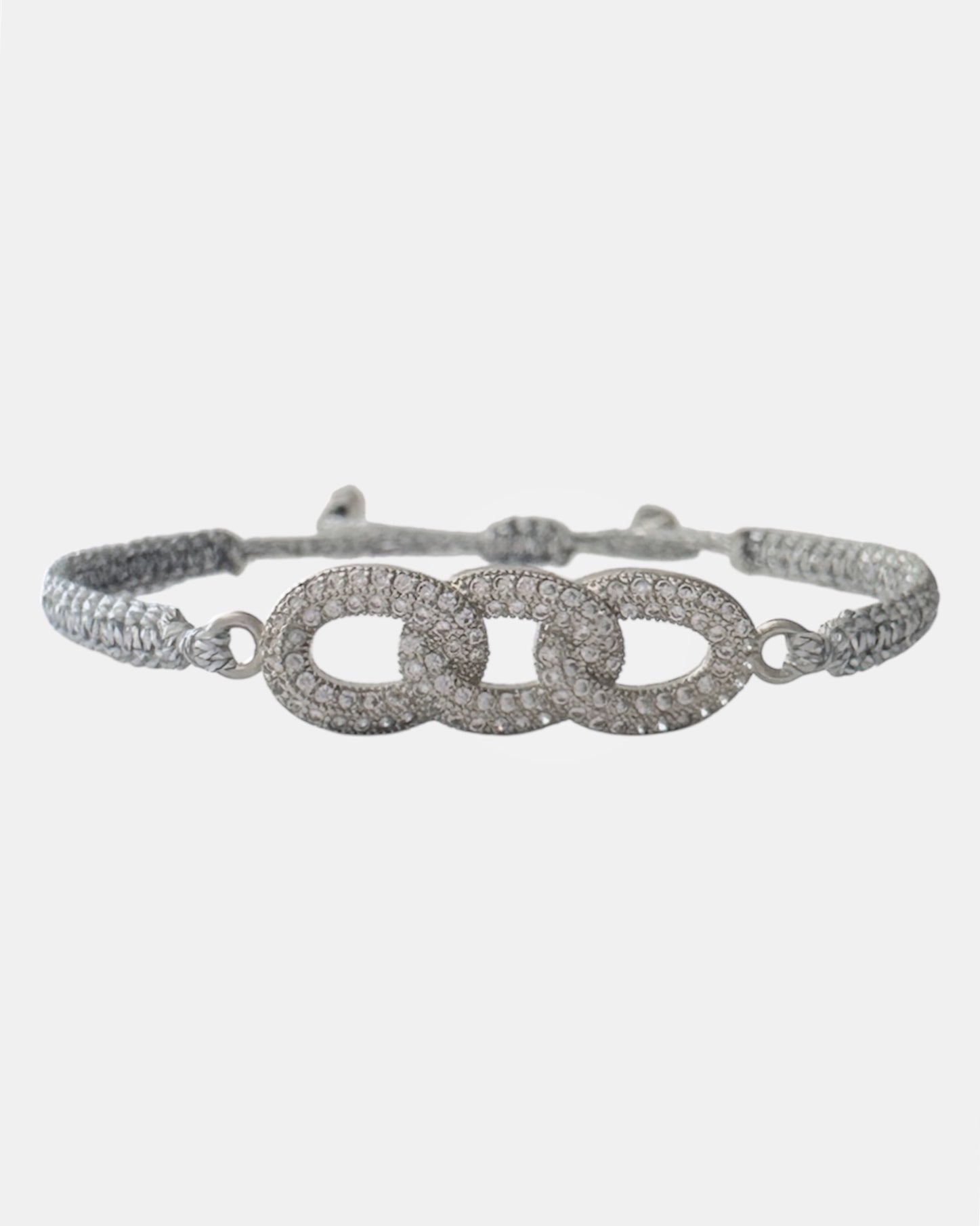 Silver macrame bracelet with triple ring zircon charm