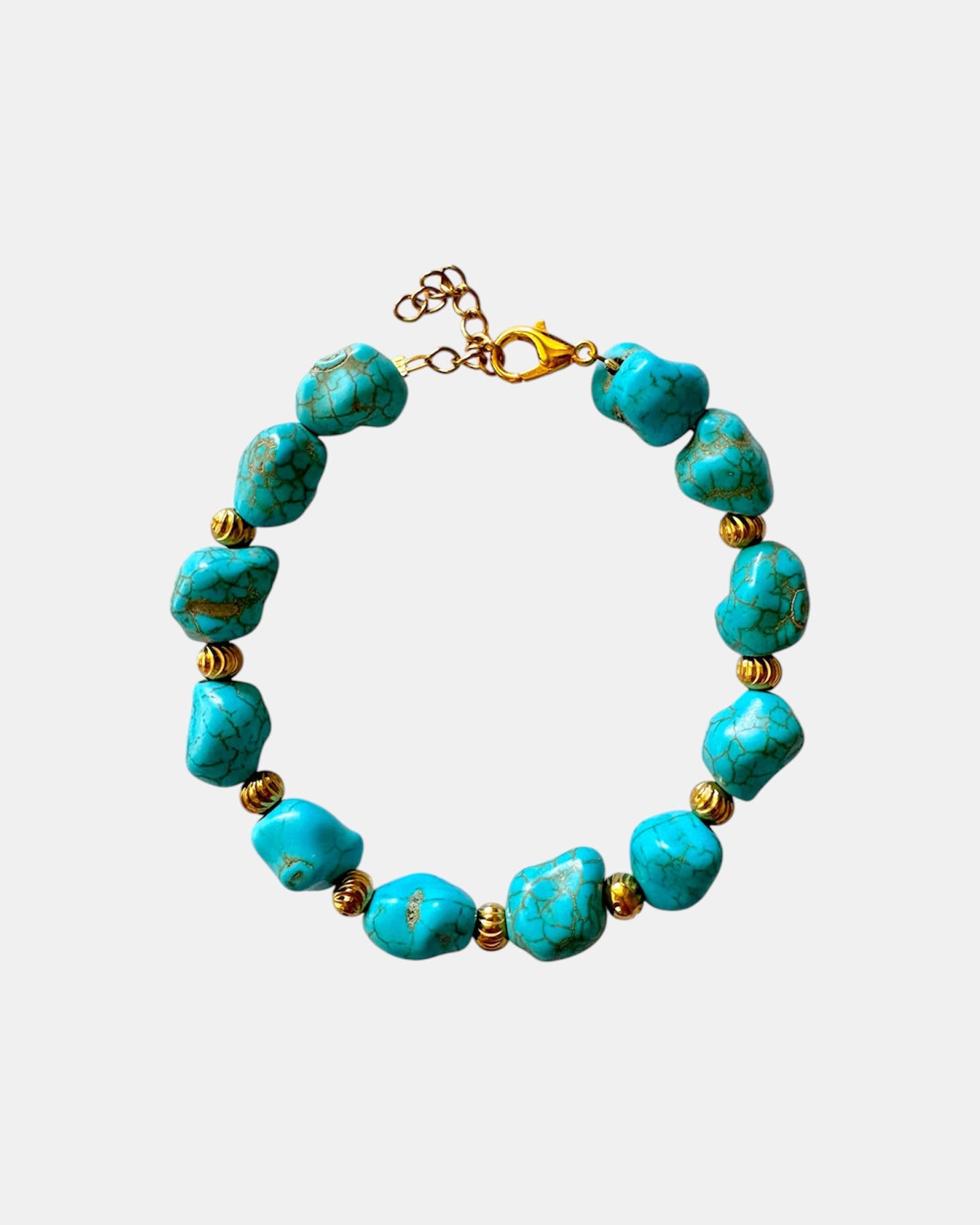 Turquoise bracelet featuring irregular-shaped stones and gold beads for a unique, bohemian style