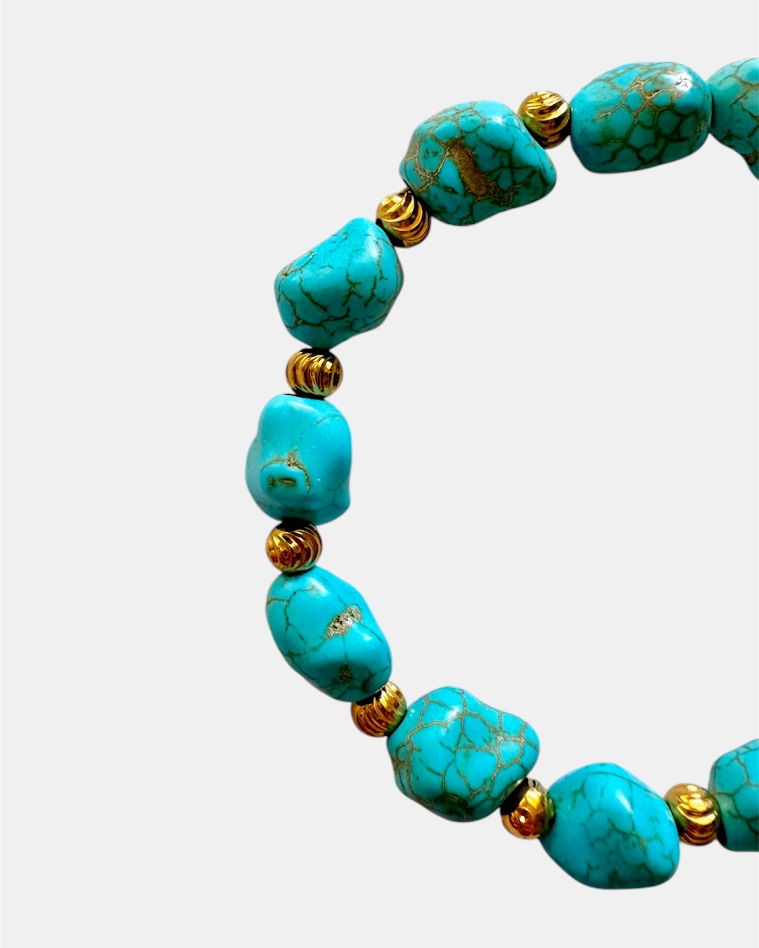 Turquoise bracelet featuring irregular-shaped stones and gold beads for a unique, bohemian style