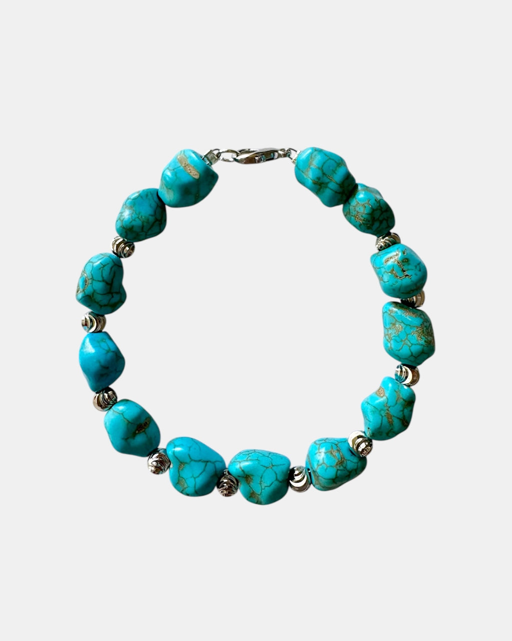 Turquoise bracelet featuring irregular-shaped stones and silver beads for a stylish, bohemian look