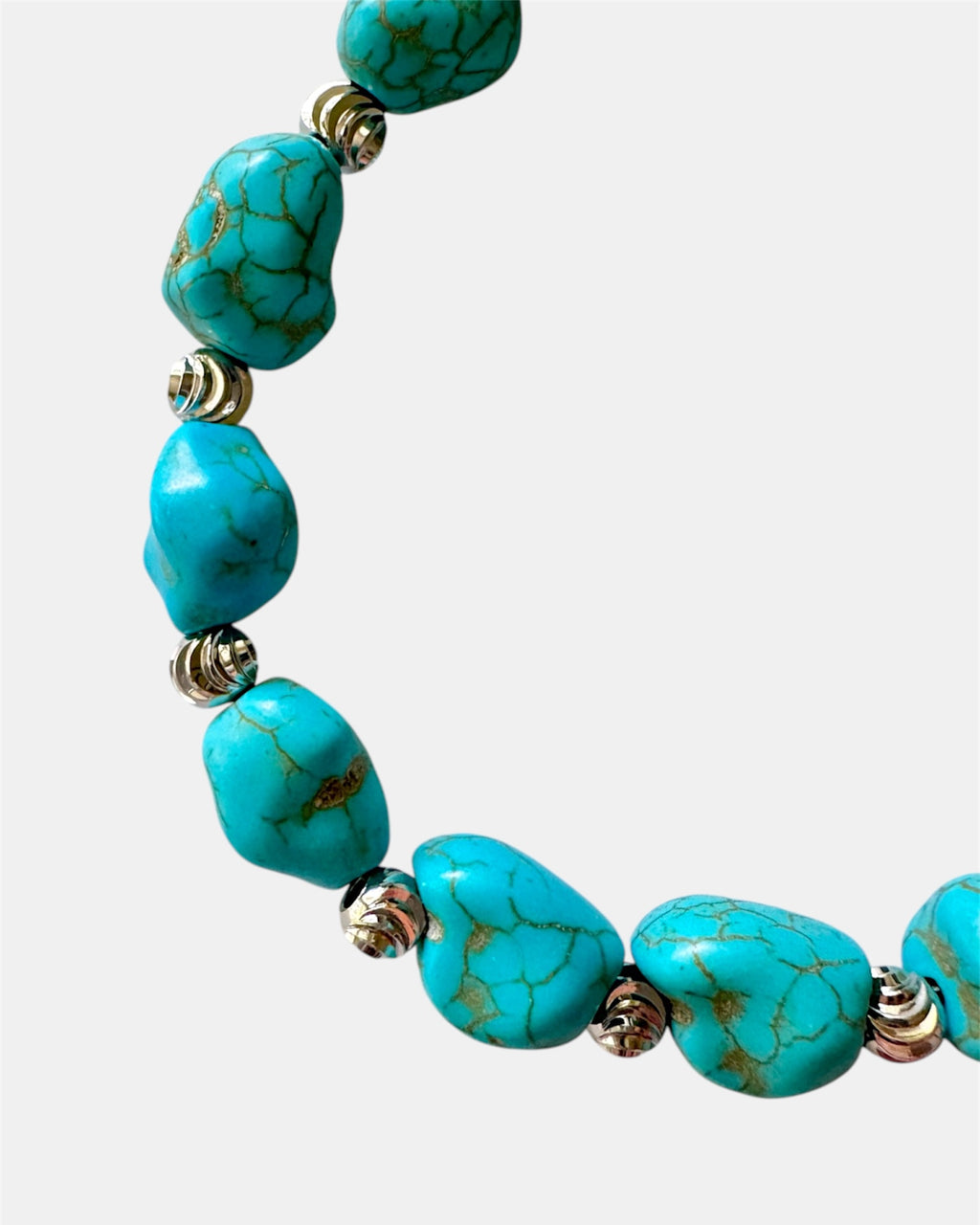 Turquoise bracelet featuring irregular-shaped stones and silver beads for a stylish, bohemian look