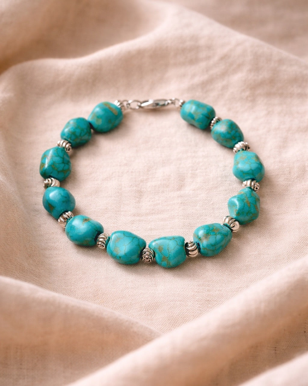 Turquoise bracelet featuring irregular-shaped stones and silver beads for a stylish, bohemian look