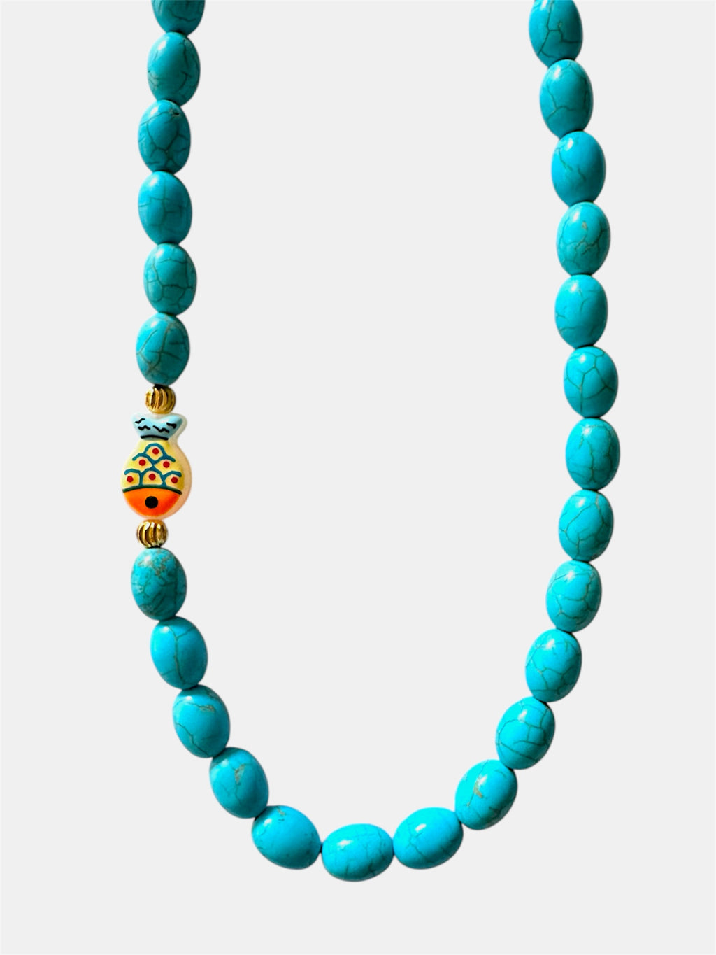 Turquoise necklace featuring a decorative fish charm for a playful and ocean-inspired accessory