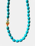 Turquoise necklace featuring a decorative fish charm for a playful and ocean-inspired accessory