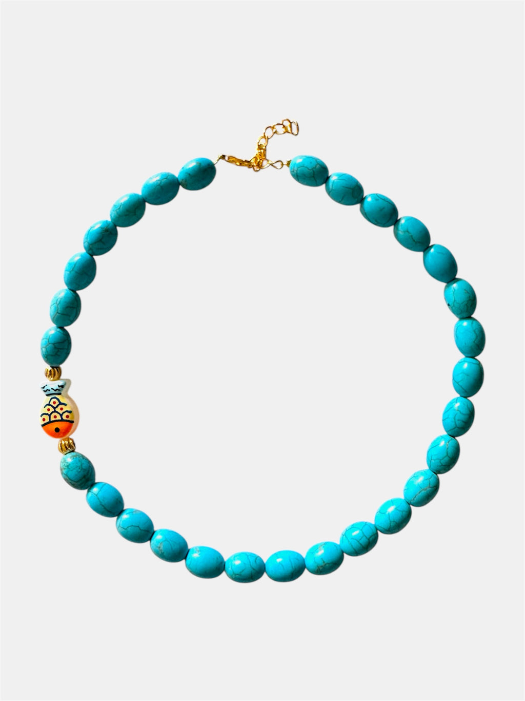 Turquoise necklace featuring a decorative fish charm for a playful and ocean-inspired accessory