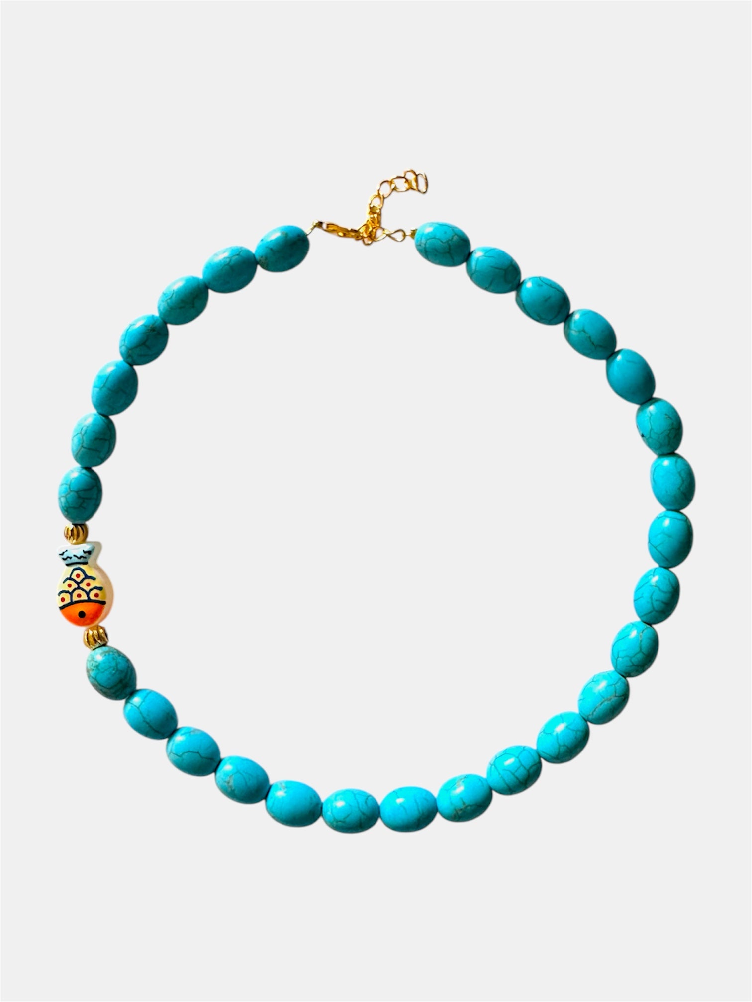 Turquoise necklace featuring a decorative fish charm for a playful and ocean-inspired accessory