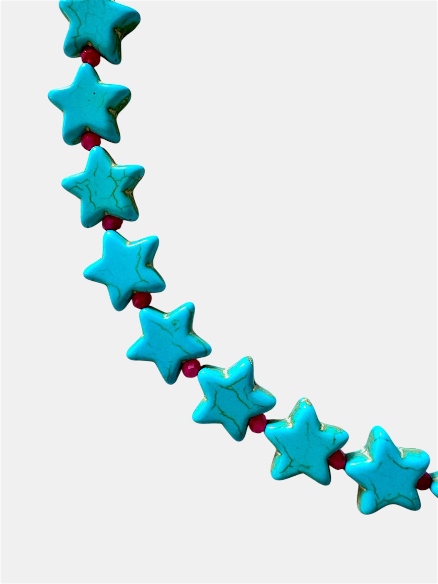 Necklace with blue star-shaped beads on a white background