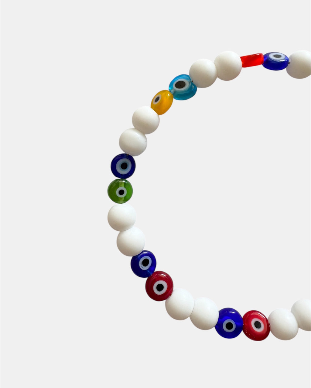 Bracelet with white beads and multicolored evil eye beads on a white background