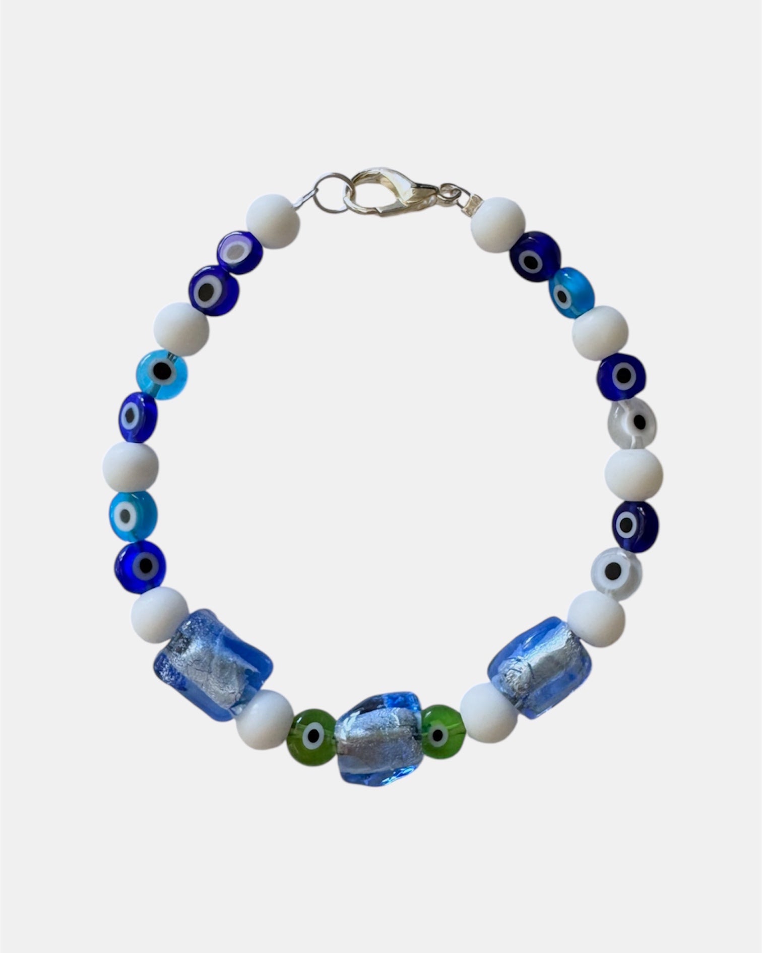 white bracelet with glass blue beads and evil eye charms, handmade jewelry piece for women and girls
