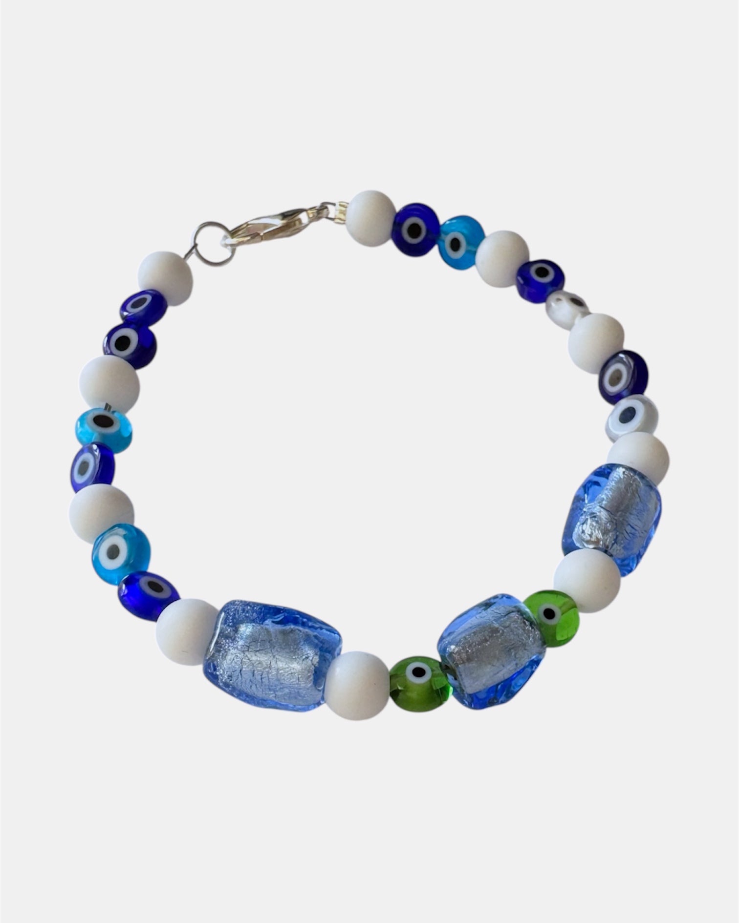 white bracelet with glass blue beads and evil eye charms, handmade jewelry piece for women and girls