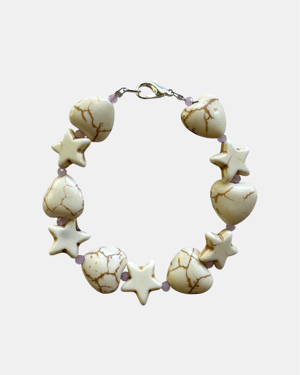 White bracelet with heart and star charms in elegant minimalist style