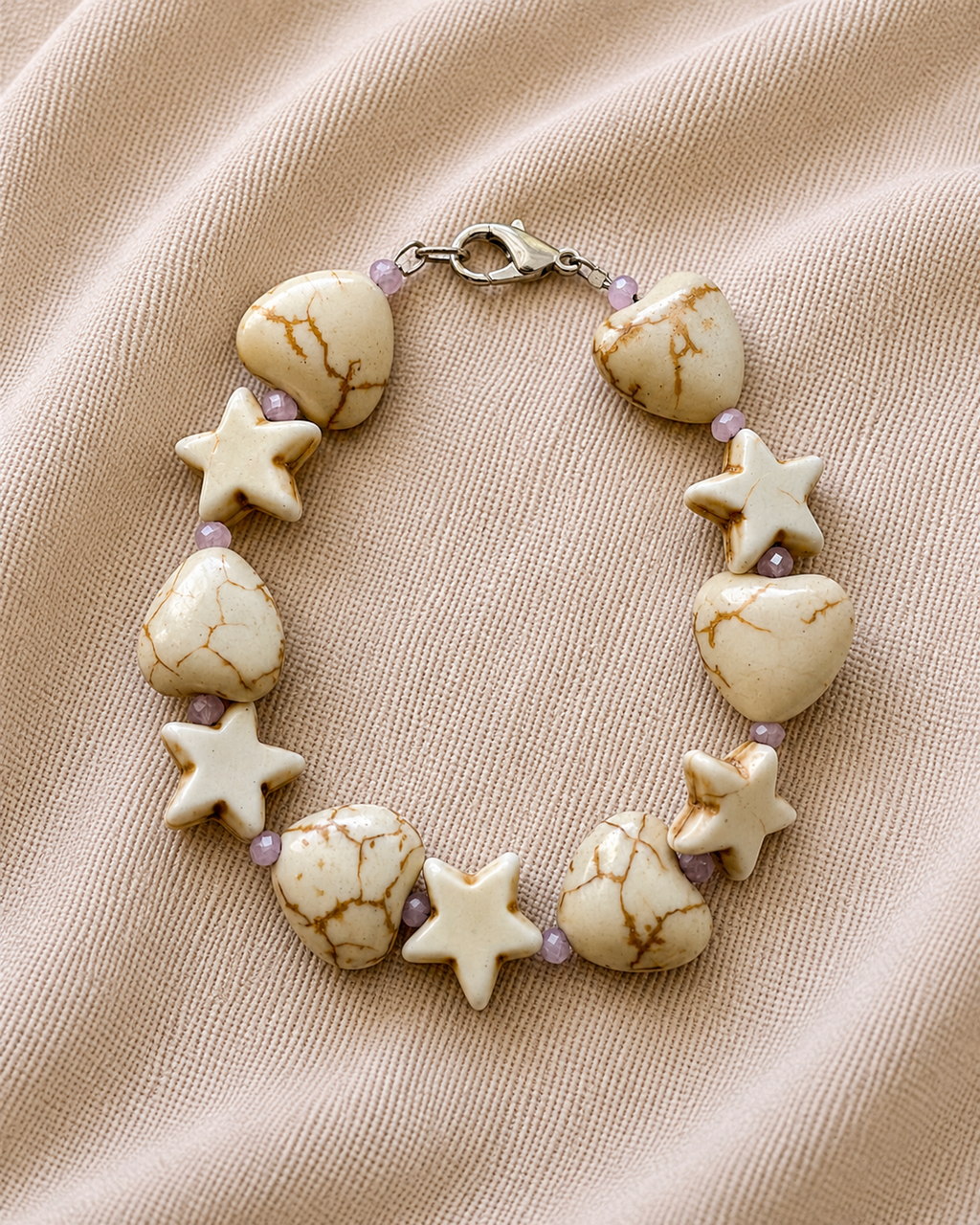 White bracelet with heart and star charms in elegant minimalist style