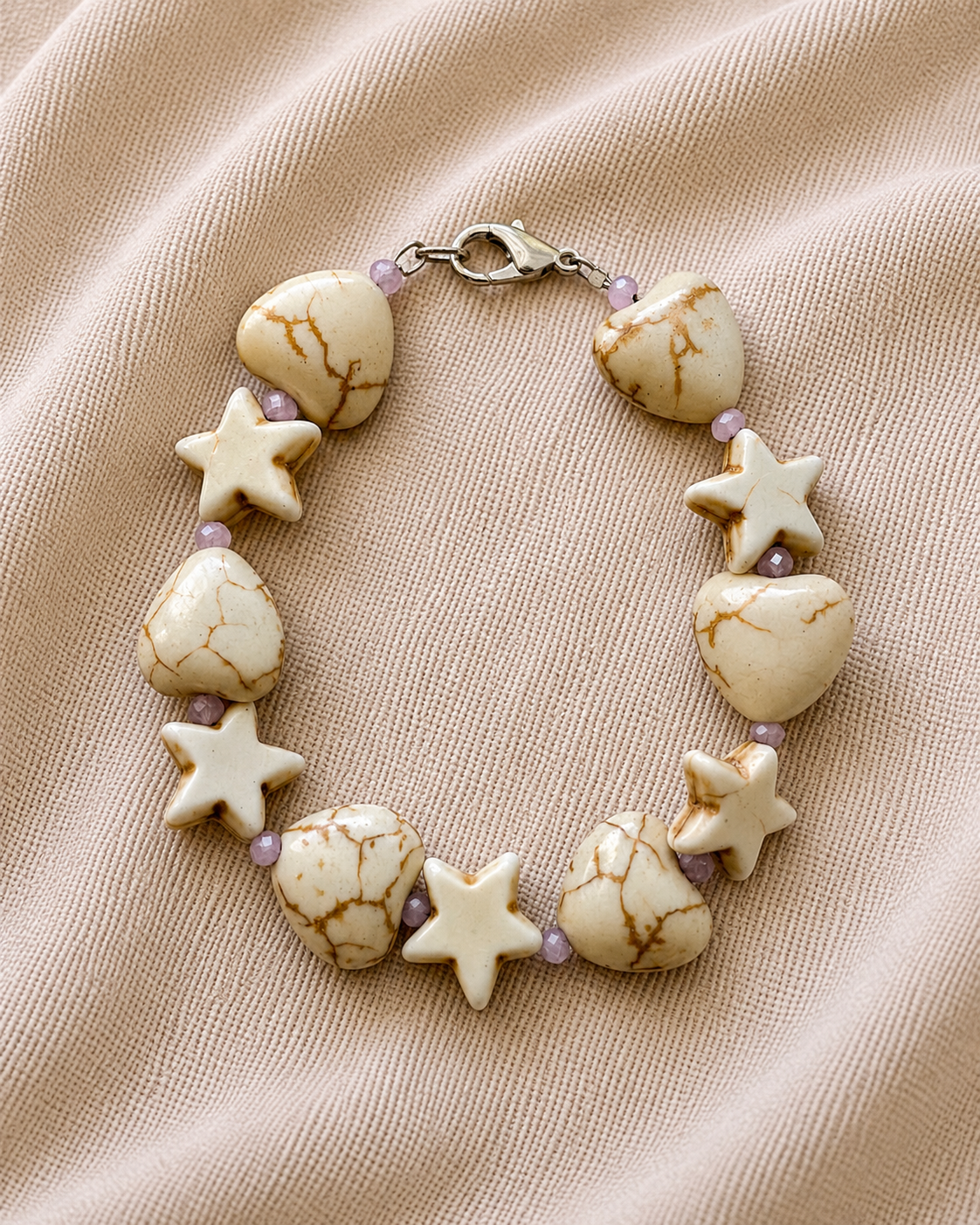 White bracelet with heart and star charms in elegant minimalist style