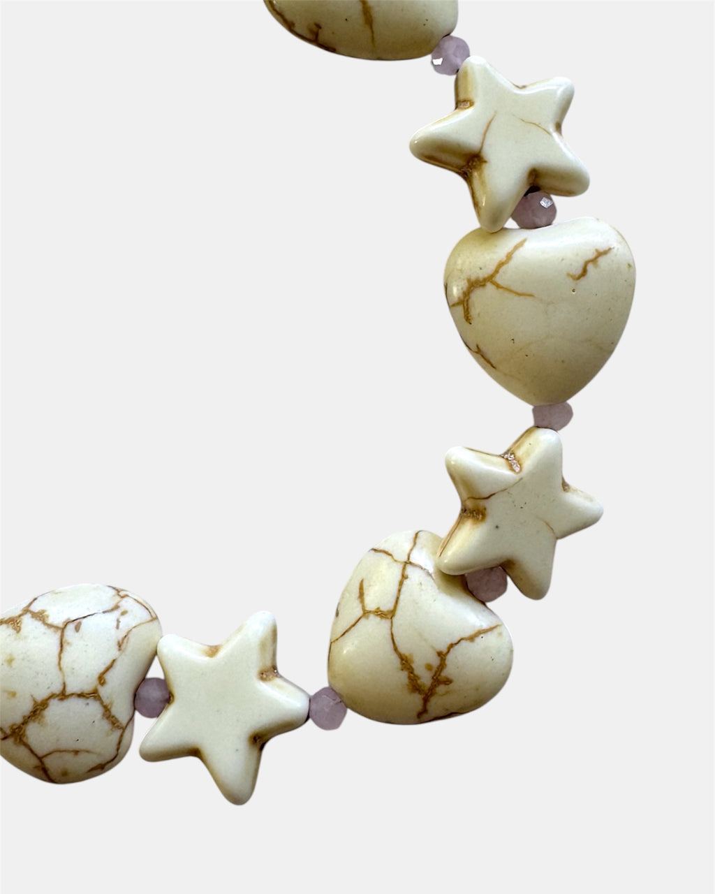 White bracelet with heart and star charms in elegant minimalist style