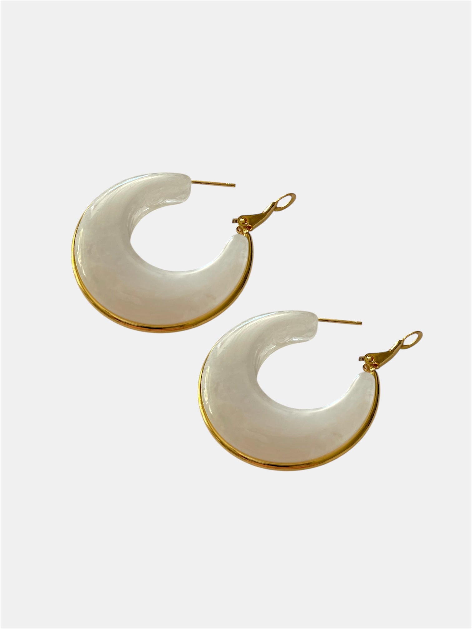 White hoop earrings with gold accents.