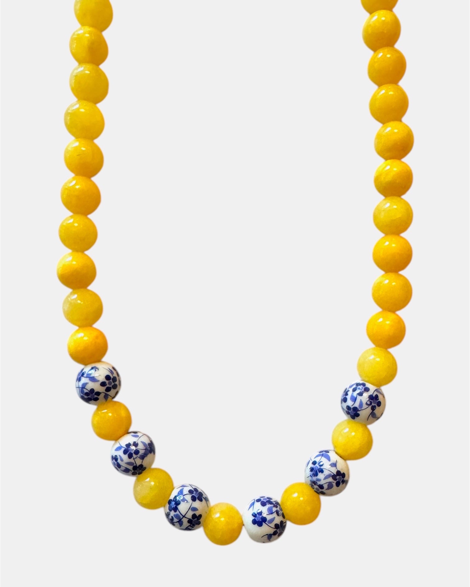 Yellow beaded necklace featuring ceramic accents for a cheerful and stylish look