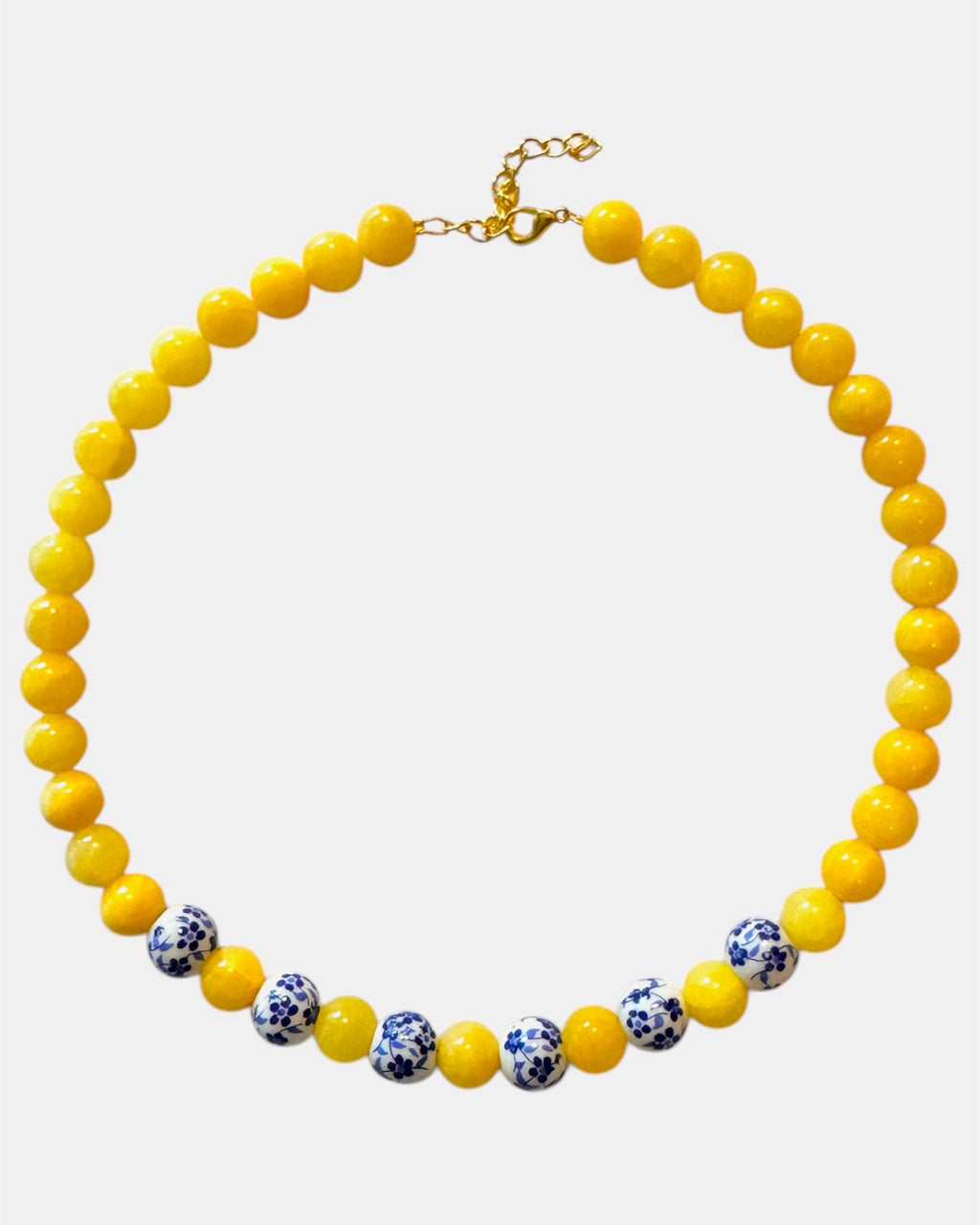 Yellow beaded necklace featuring ceramic accents for a cheerful and stylish look