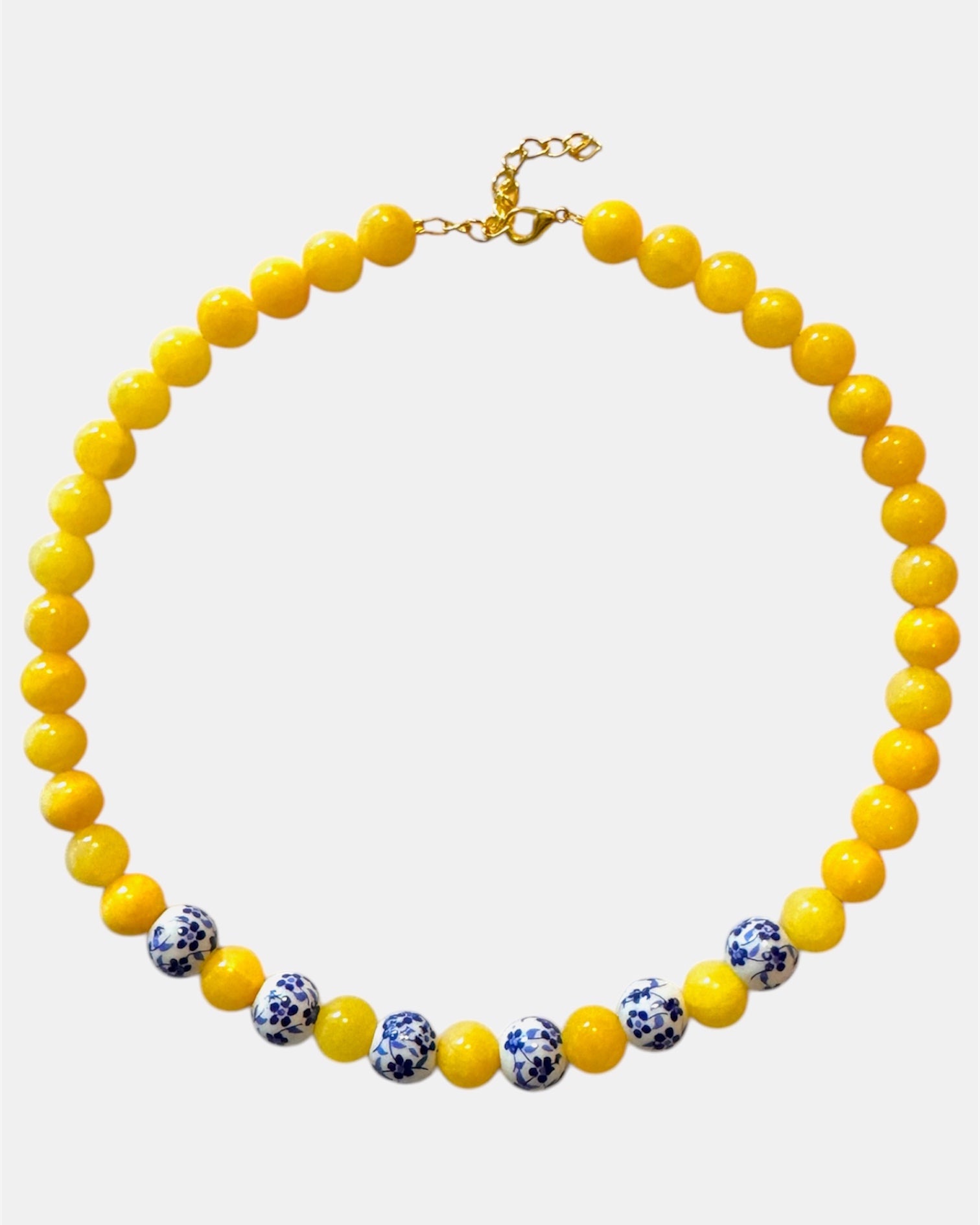Yellow beaded necklace featuring ceramic accents for a cheerful and stylish look