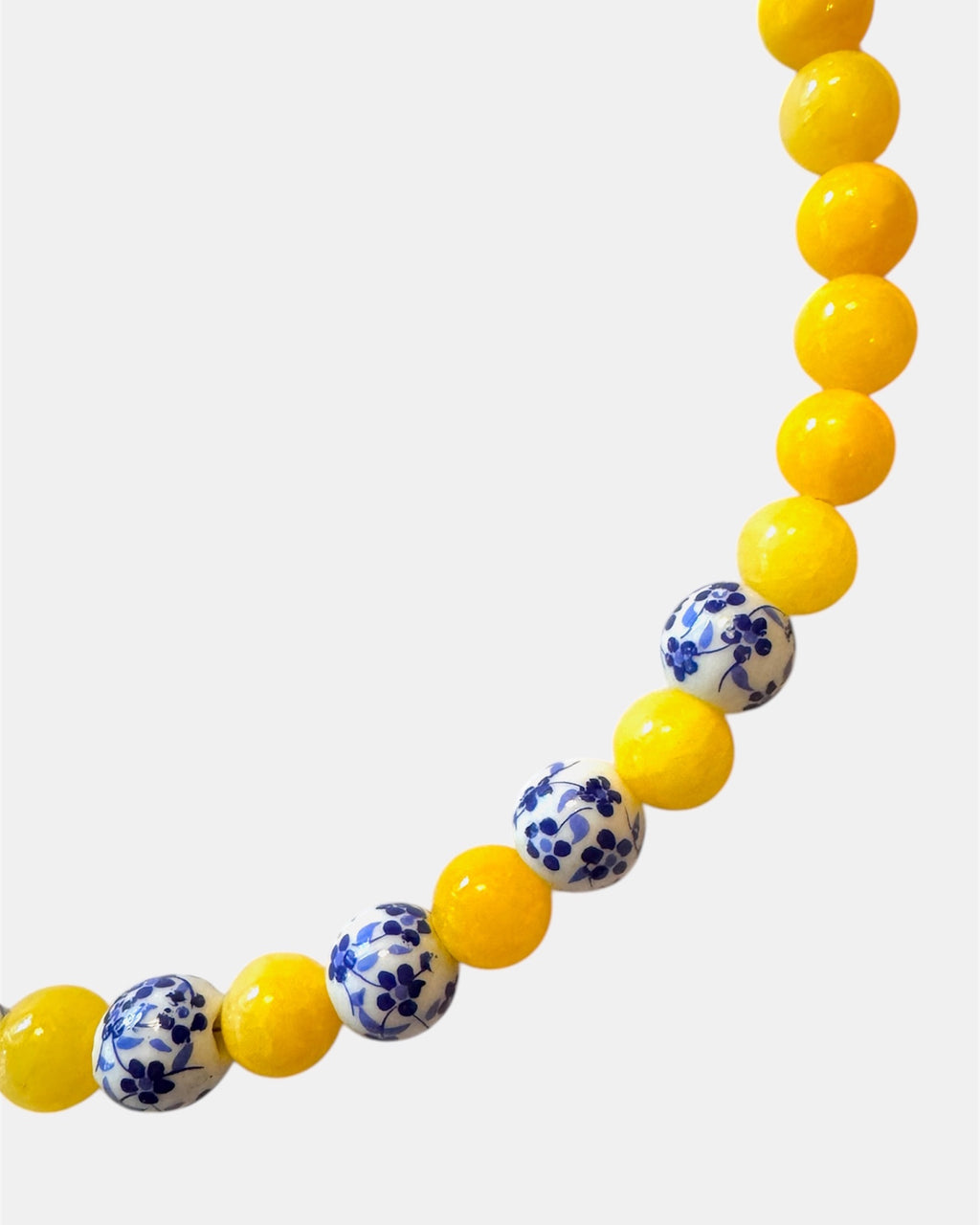 Yellow beaded necklace featuring ceramic accents for a cheerful and stylish look