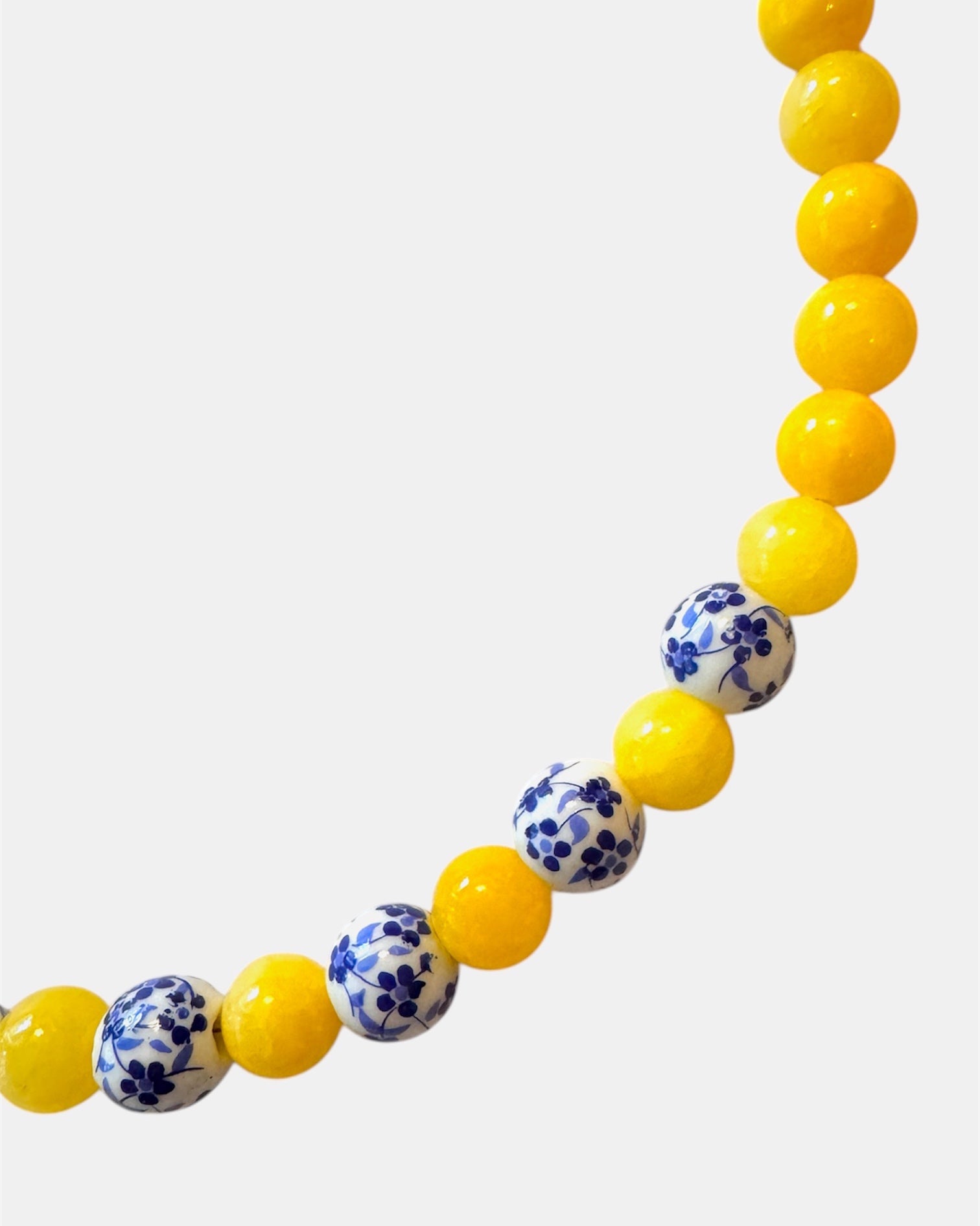 Yellow beaded necklace featuring ceramic accents for a cheerful and stylish look